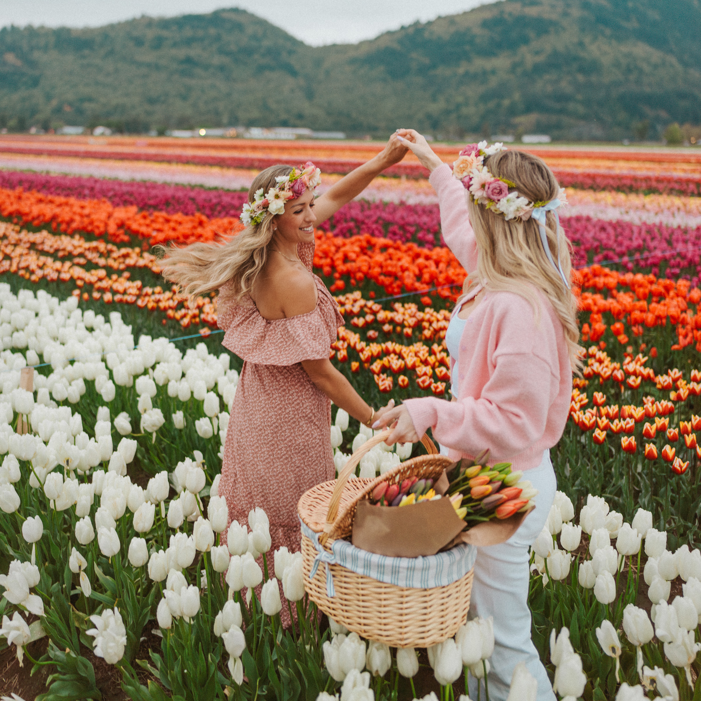 Two women playfully holding a bouquet of tulips at the Abbotsford Tulip Festival
